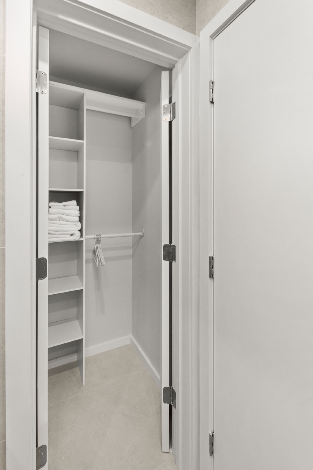 Linen closet stocked with fresh towels